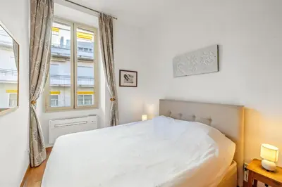 a bedroom with a white bed and a window at REF 2038 - Cannes - Superb fully renovated one-bedroom apartment in Cannes