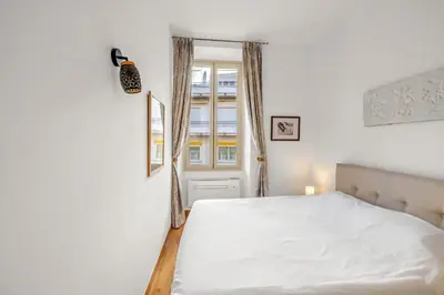 a bedroom with a white bed and a window at REF 2038 - Cannes - Superb fully renovated one-bedroom apartment in Cannes