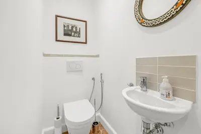 a bathroom with a sink and a toilet and a mirror at REF 2038 - Cannes - Superb fully renovated one-bedroom apartment in Cannes