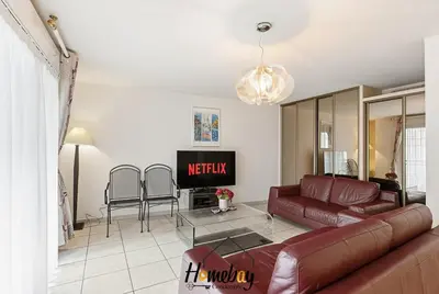 a living room with a couch and a tv at Le Palazzio in Cannes