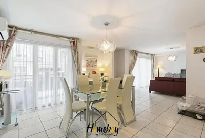 a dining room with a glass table and chairs at Le Palazzio in Cannes