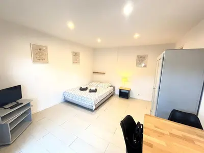 a bedroom with a bed and a tv in it at Ideal Congress MIPIM terrace calm 1 kms from Palais in Cannes