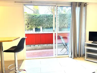 a living room with a sliding glass door at Ideal Congress MIPIM terrace calm 1 kms from Palais in Cannes