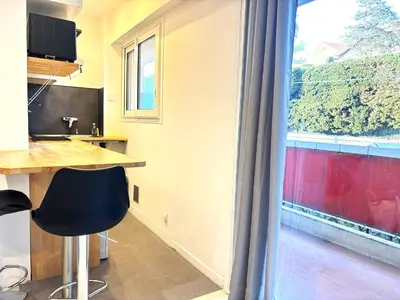 a kitchen with a table and a large window at Ideal Congress MIPIM terrace calm 1 kms from Palais in Cannes