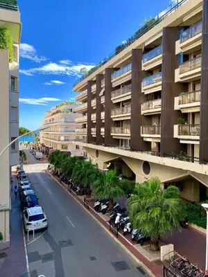 a city street with cars parked in a parking lot at Charming Studio near Croisette in Cannes