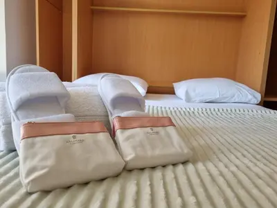 a bed with two towels on top of it at Charming Studio near Croisette in Cannes