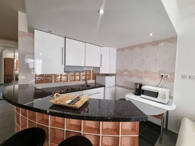 a kitchen with a black counter top and a microwave at Charming Studio near Croisette in Cannes