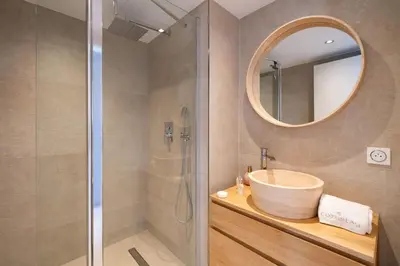 a bathroom with a shower and a sink and a mirror at COZYSTAY 1700 -Luxury 3-Bedroom Apartment with Terrace & Sea View in Cannes in Cannes