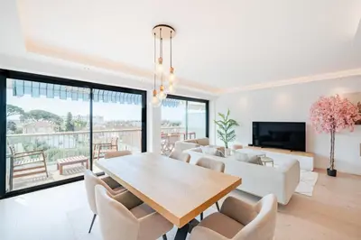 a dining room with a table and chairs at COZYSTAY 1700 -Luxury 3-Bedroom Apartment with Terrace & Sea View in Cannes in Cannes