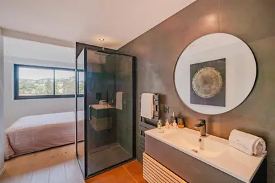 a bathroom with a shower and a sink and a mirror at COZYSTAY 1700 -Luxury 3-Bedroom Apartment with Terrace & Sea View in Cannes in Cannes