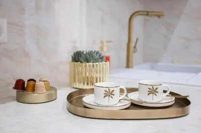 two coffee cups and saucers on a tray in a bathroom at Studio Méro by Halldis in Cannes