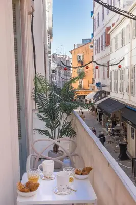 a balcony with a table with food on it at Studio Méro by Halldis in Cannes