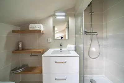 a bathroom with a white sink and a shower at Elegant renovated studio on the top floor Cannes city center in Cannes