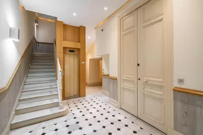 a hallway with stairs and a door in a building at Elegant renovated studio on the top floor Cannes city center in Cannes
