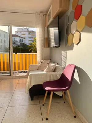a living room with a couch and a chair at Le Marvel By ApiRent #Climatisation #Central #Balcon in Cannes
