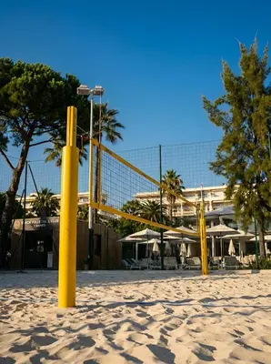 a volleyball net in the sand in front of a building at Long Beach Apartment Cannes in Cannes