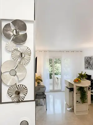 a kitchen with white walls and a table with plates at Long Beach Apartment Cannes in Cannes