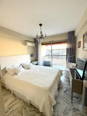a bedroom with a large bed and a window at T2 derrière le Martinez - Croisette in Cannes