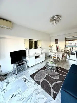 a living room with a tv and a couch at T2 derrière le Martinez - Croisette in Cannes