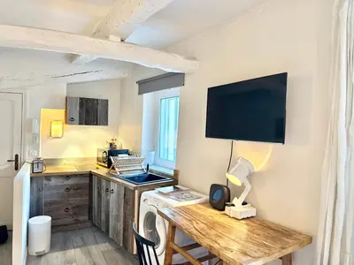 a kitchen with a desk and a tv on the wall at Elegant studio in Cannes - Le Suquet - 2 people in Cannes