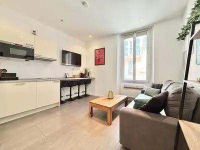 a living room with a couch and a table at Cannes one bedroom apartment - 12RP2 in Cannes