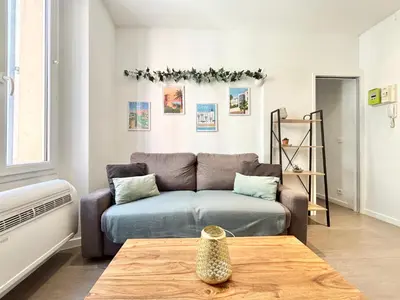 a living room with a couch and a table at Cannes one bedroom apartment - 12RP2 in Cannes