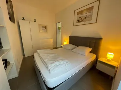 a white bedroom with a white bed and a wall withmbermbermbermbermber at Cannes one bedroom apartment - 12RP2 in Cannes