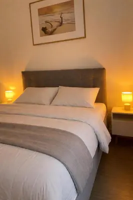 a white bedroom with a bed and a window at Cannes one bedroom apartment - 12RP2 in Cannes