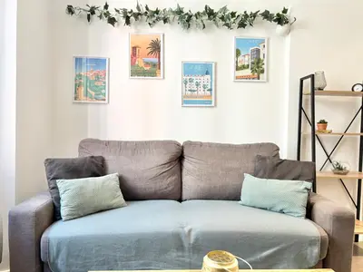 a couch in a living room with pictures on the wall at Cannes one bedroom apartment - 12RP2 in Cannes