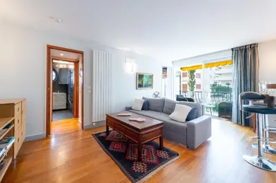 a living room with a couch and a table at 1-Br Apartment in Cannes Peaceful Seaside Atmosphere in Cannes