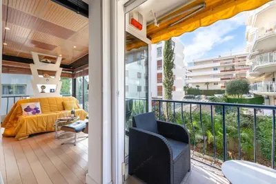 a balcony with a couch and chairs on it at 1-Br Apartment in Cannes Peaceful Seaside Atmosphere in Cannes