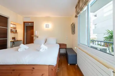 a bedroom with two beds and a large window at 1-Br Apartment in Cannes Peaceful Seaside Atmosphere in Cannes