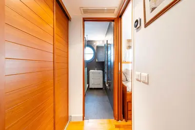 a hallway with a wooden door leading into a bathroom at 1-Br Apartment in Cannes Peaceful Seaside Atmosphere in Cannes