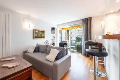 a living room with a couch and a table at 1-Br Apartment in Cannes Peaceful Seaside Atmosphere in Cannes