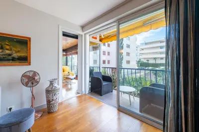 a living room with a balcony with a view at 1-Br Apartment in Cannes Peaceful Seaside Atmosphere in Cannes