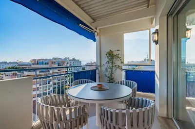 a balcony with a table and chairs and a view at Top floor 3 Bedroom near the Croisette in Cannes