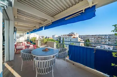 a balcony with a table and chairs and a view at Top floor 3 Bedroom near the Croisette in Cannes