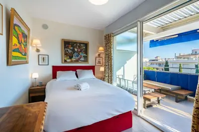 a bedroom with a large bed and a balcony at Top floor 3 Bedroom near the Croisette in Cannes