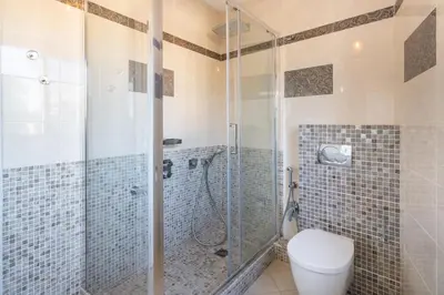a bathroom with a toilet and a glass shower at Top floor 3 Bedroom near the Croisette in Cannes