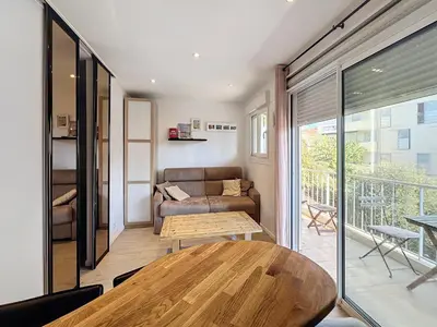 a living room with a couch and a table at Superbe appartement meublé Cannes centre in Cannes