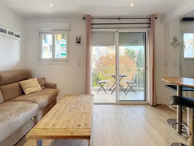 a living room with a couch and a wooden table at Superbe appartement meublé Cannes centre in Cannes
