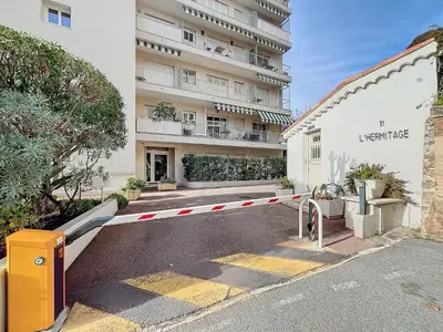 a parking lot in front of a large building at Superbe appartement meublé Cannes centre in Cannes