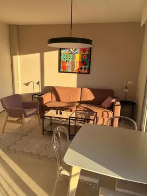 a living room with a couch and a table at Armenonvillecannes in Cannes