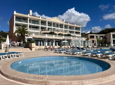 a large hotel with a swimming pool in front of a building at Splendid view Apartment in Cannes in Cannes
