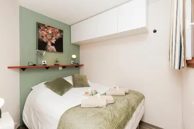 a bedroom with two beds with towels on them at Vue mer piscine parking tennis 4 personnes in Cannes