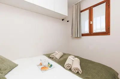 a bedroom with a bed with towels on it at Vue mer piscine parking tennis 4 personnes in Cannes