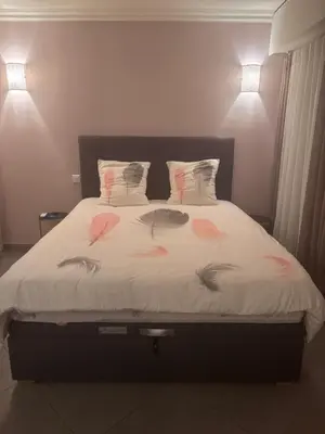 a bedroom with a bed with feathers on it at Studio Palais Rouaze-50m de la Croisette in Cannes