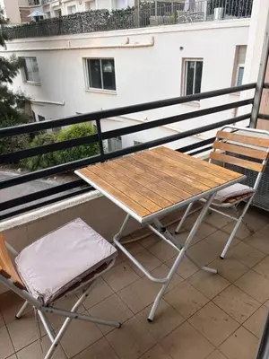 a picnic table and chairs on a balcony at Studio Palais Rouaze-50m de la Croisette in Cannes
