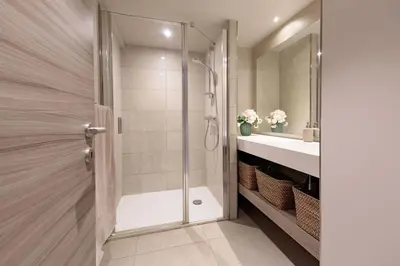 a bathroom with a shower and a sink at Villa Lerins 411 by Halldis in Cannes