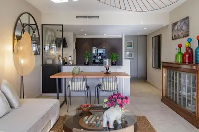 a living room with a couch and a table at Villa Lerins 411 by Halldis in Cannes
